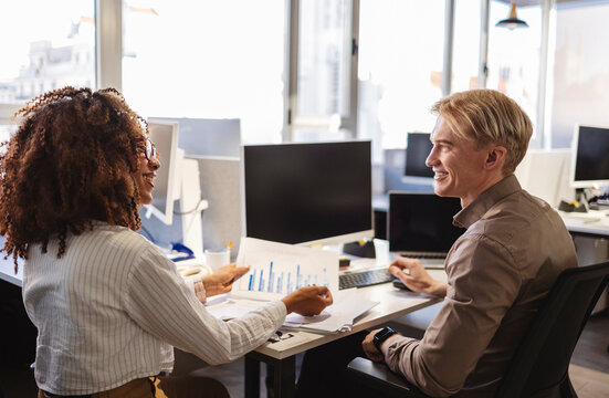 Business people discussing charts in modern office - Powered by Adobe