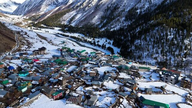Aerial drone shot showcasing the breathtaking winter landscape of Chitkul blanketed in snow.