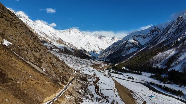 Aerial drone shot capturing the serene, snow-clad surroundings of Chitkul in Himachal Pradesh.