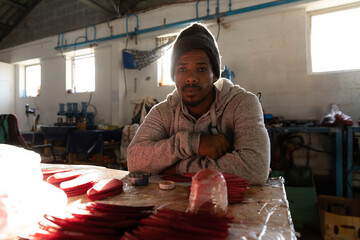 Man in workshop crafting sport shoe soles, focused and determined on task