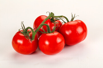 Ripe fresh tomato on the branch