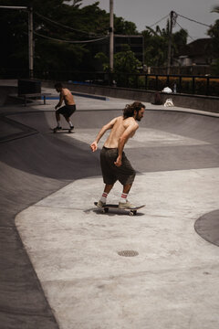 Young men skateboarding in skate park, Canggu, Bali, Indonesia