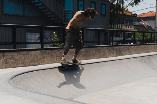 Young men skateboarding in skate park, Canggu, Bali, Indonesia