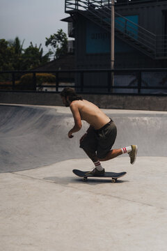 Young men skateboarding in skate park, Canggu, Bali, Indonesia