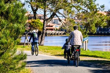 Fototapeta premium Family cycling around Lake Vieux-Boucau in southwest France