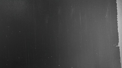 Black grunge textured background with vintage film grain and dust scratches overlay. Abstract dark backdrop design for print, cover art, or creative projects in retro aged distressed style. Minimal mo