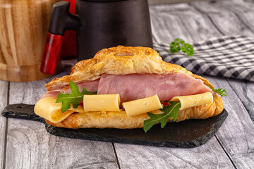 Fresh croissant with ham and cheese