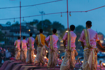 the Ganga Aarti ceremony in Varanasi, India, where Hindu priests perform a ritual with fire lamps, prayers, and chanting along the sacred Ganges River.