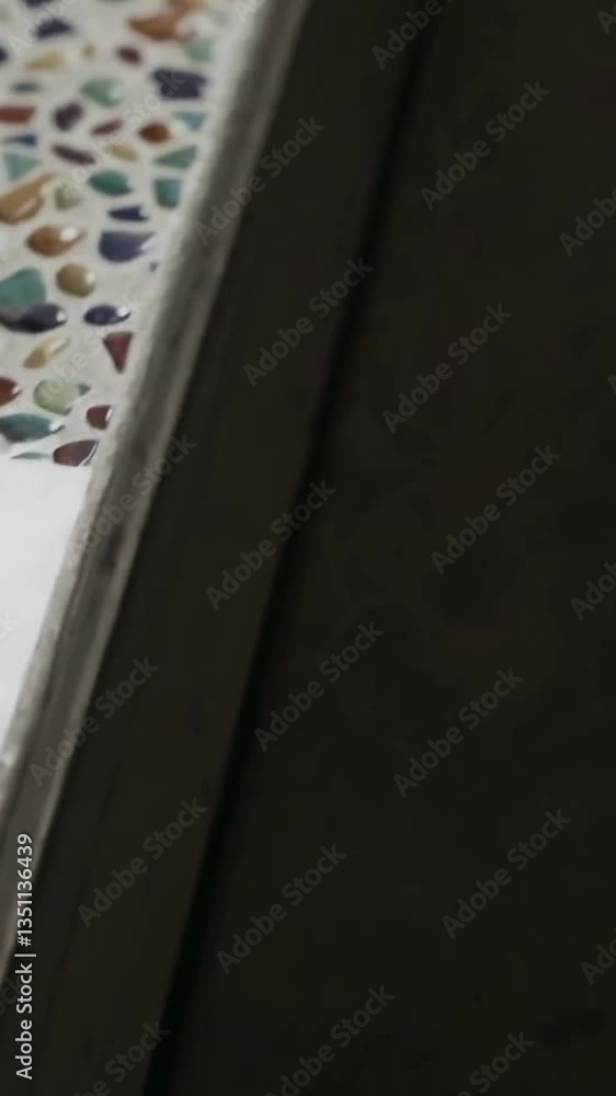 Poster closeup transition of colorful pebbles on a mosaic surface from above to edge view
