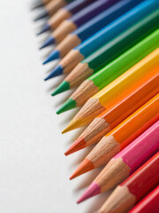 Fototapeta premium Colorful Pencils Arranged in a Rainbow Pattern on a White Background