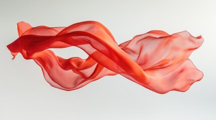 Flowing red fabric gracefully suspended in mid-air against a soft white background, creating a sense of elegance
