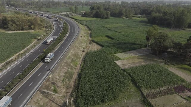 Drone shot video of national highway. 4k Aerial view village Road, Drone view Highway, Countryside Road. Drone shot high angle Aerial view of the road at the village side. Raw footage. India