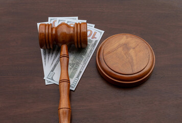 A powerful representation of financial judgment, showing a gavel placed on top of cash, signifying...