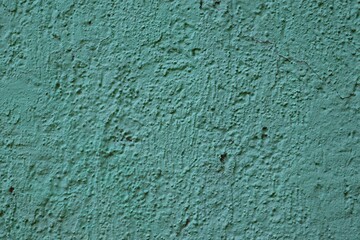 Background, texture wall covered with rough plaster of green color