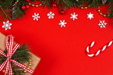 Christmas decorative border with green spruce, holly berries, snowflakes, candy cane and craft...
