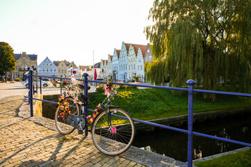 Fototapeta premium View of the canal and surrounding area in Friedrichstadt, a climatic health resort in North Frisia. 