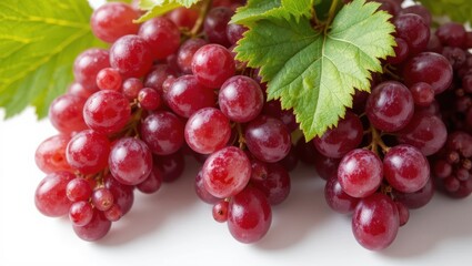 Fototapeta premium Close Up of Fresh Purple Grapes with Green Leaves on White Background