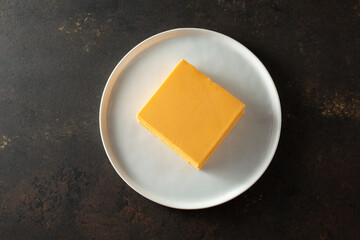 A top down view of a stack of dairy-free cheddar style cheese slices.