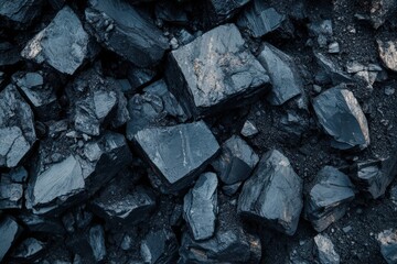 Black coal rocks scattered unevenly across the ground surface