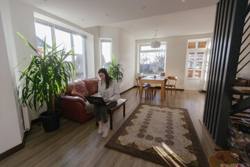Woman working using laptop from home 