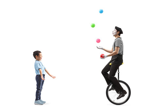 Asian boy watching a mime juggling