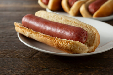 A closeup view of a hot dog on a plate.
