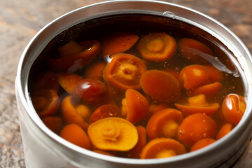 A closeup view of a pile of canned nameko mushrooms.