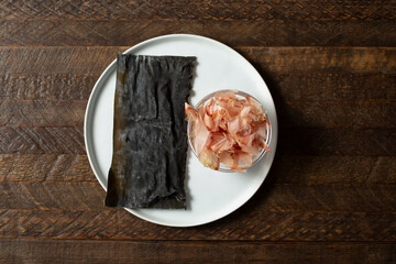 A top down view of a plate of kombu and katsuobushi.