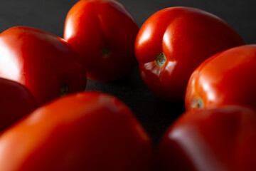 A closeup view of a circle of Roma tomatoes.