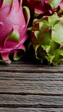 Vibrant dragon fruits on rustic wooden surface highlight exotic freshness and natural texture