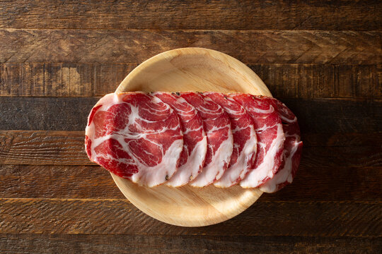 A top down view of a stack of capocollo slices.