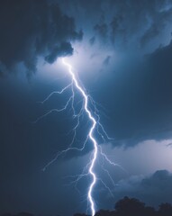 A powerful bolt of lightning illuminates the dark sky during a nighttime thunderstorm