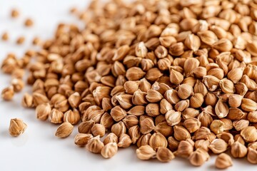 Brown Buckwheat Groats Piled on a White Reflective Surface