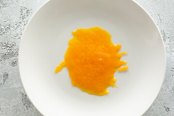 A top down view of a plate of melted cheese.