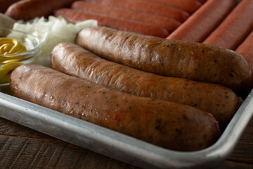 A closeup view of a tray with a variety of hot dogs, featuring chicken sausage.