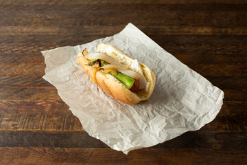 A view of a Seattle hot dog, on parchment paper.