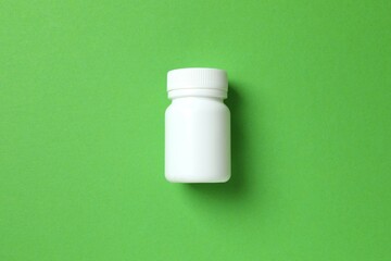 White bottle on color  background, top view