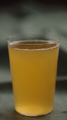 yellow drink in tumbler glas on linen cloth