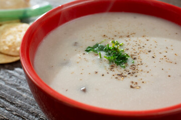 A closeup view of a bowl of cream of mushroom soup.