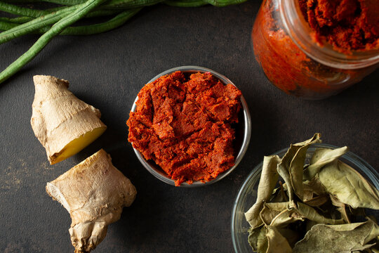 A top down view of a condiment cup of Thai red curry paste.