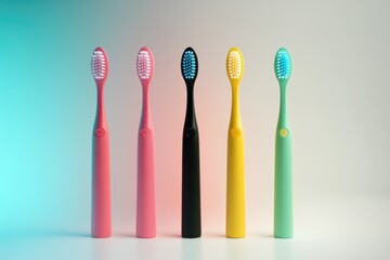 Four colorful toothbrushes arranged on a surface