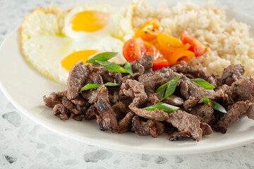 A closeup view of a beef tapa breakfast plate.