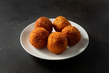 A view of some croquettes, on a plate.