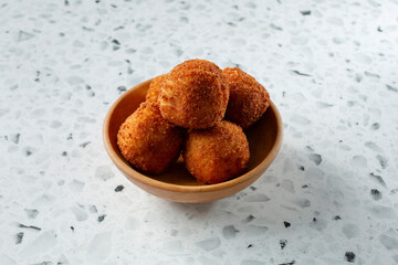 A view of some croquettes, in a bowl.