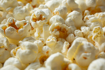 A closeup view of a pile of popcorn, as a background.
