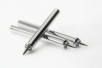 A pair of pens resting on a clean white surface, perfect for use in various office or creative settings