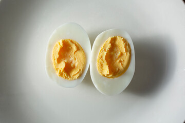 A top down view of a halved hard boiled egg.