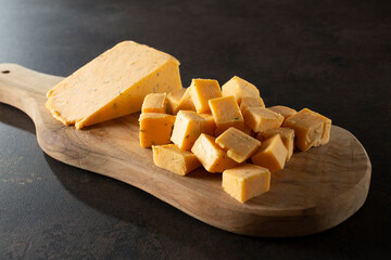 A view of a pile of double gloucester cheese chunks.