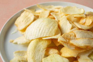 A closeup view of a plate of onion chips.