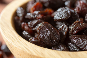 A closeup view of a bowl full of raisins.